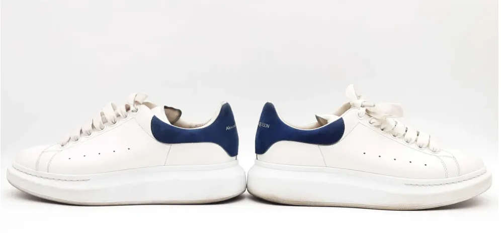 A pair of white sneakers with blue accents by Alexander McQueen.