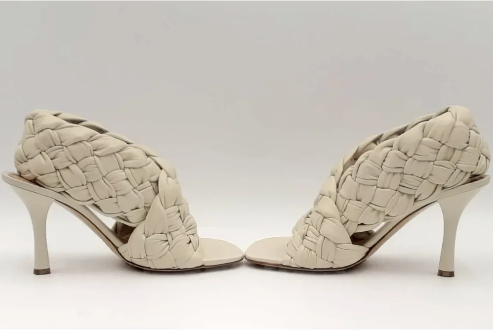 Beige high-heeled mules with a distinctive woven design by Bottega Veneta.