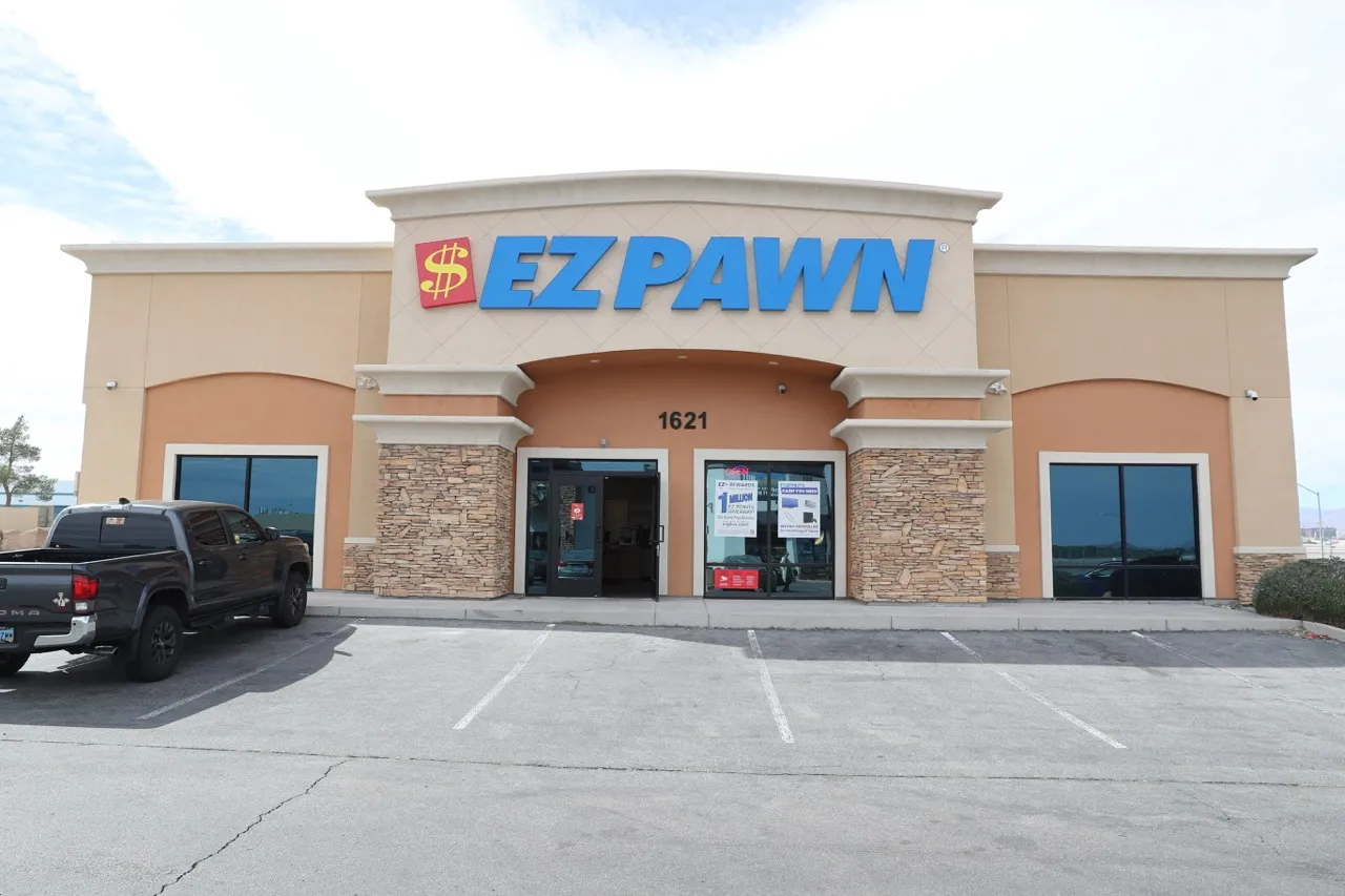 This image shows the exterior of an EZPAWN store. The store has a prominent sign with the EZPAWN logo above the entrance.