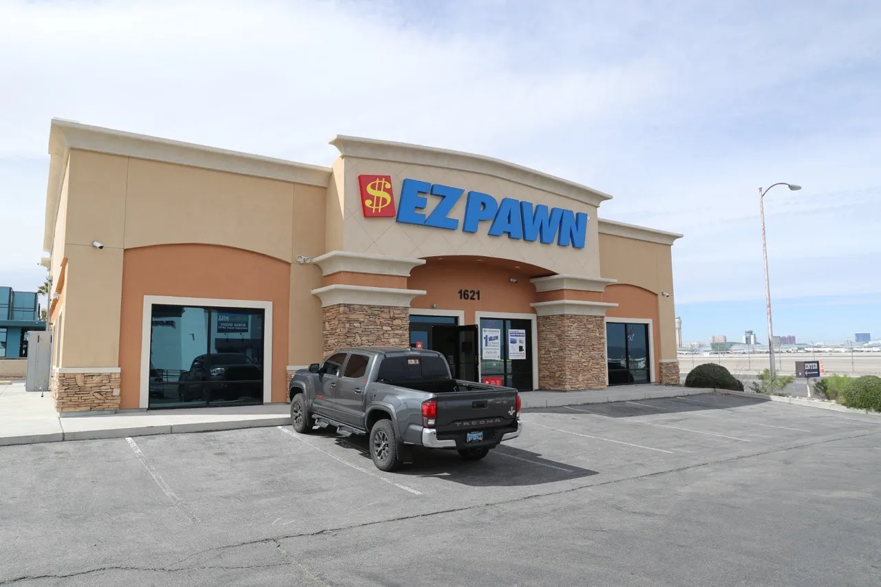 A picture of the EZPAWN store taken from the parking lot. A customer’s truck is parked in front of the store.