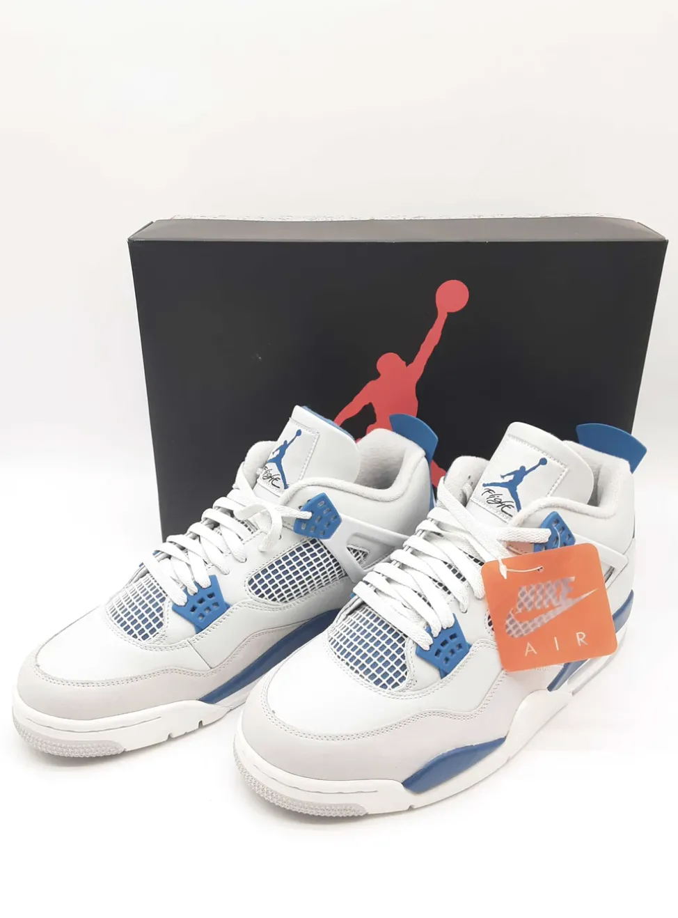 Air Jordan sneakers in white and blue, with the iconic Jumpman logo on the black box.