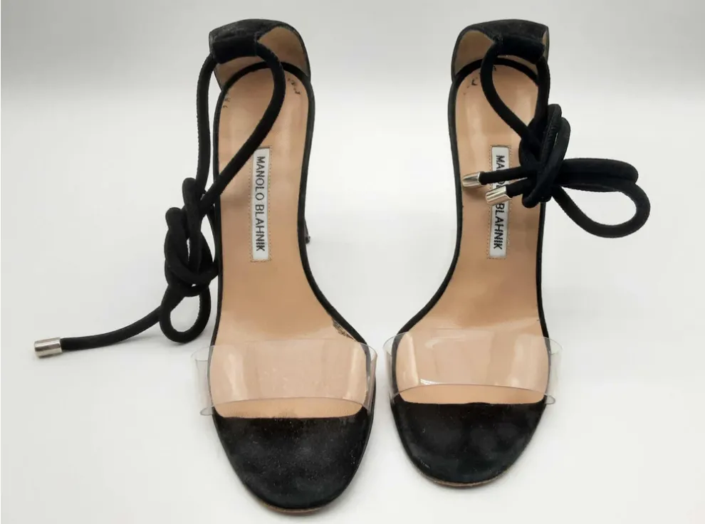 Black high-heeled sandals with distinctive laces by Manolo Blahnik.