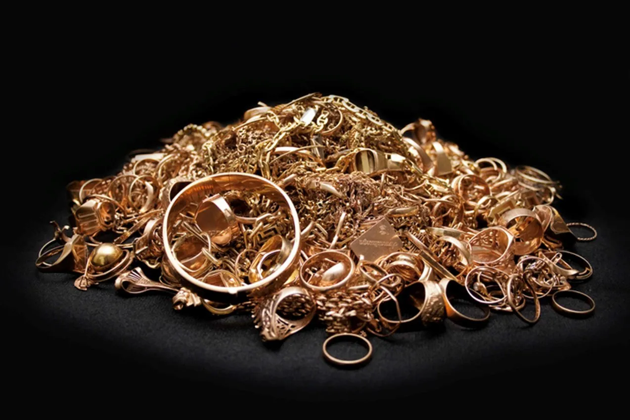 A pile of random gold jewelry on display.