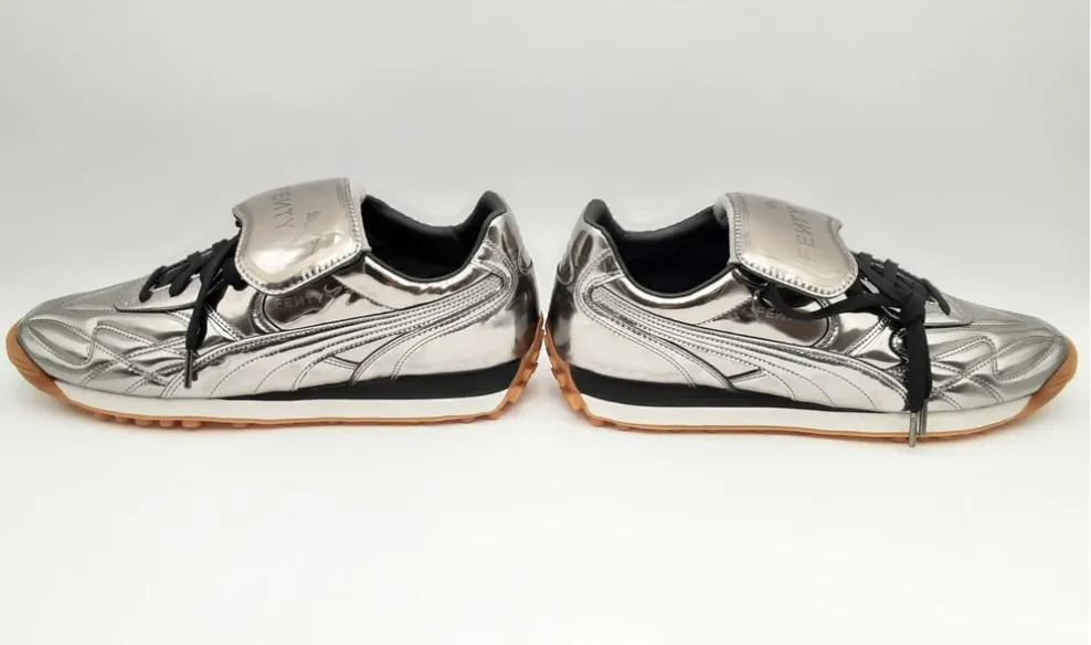 Silver Puma sneakers with a unique design and black laces.