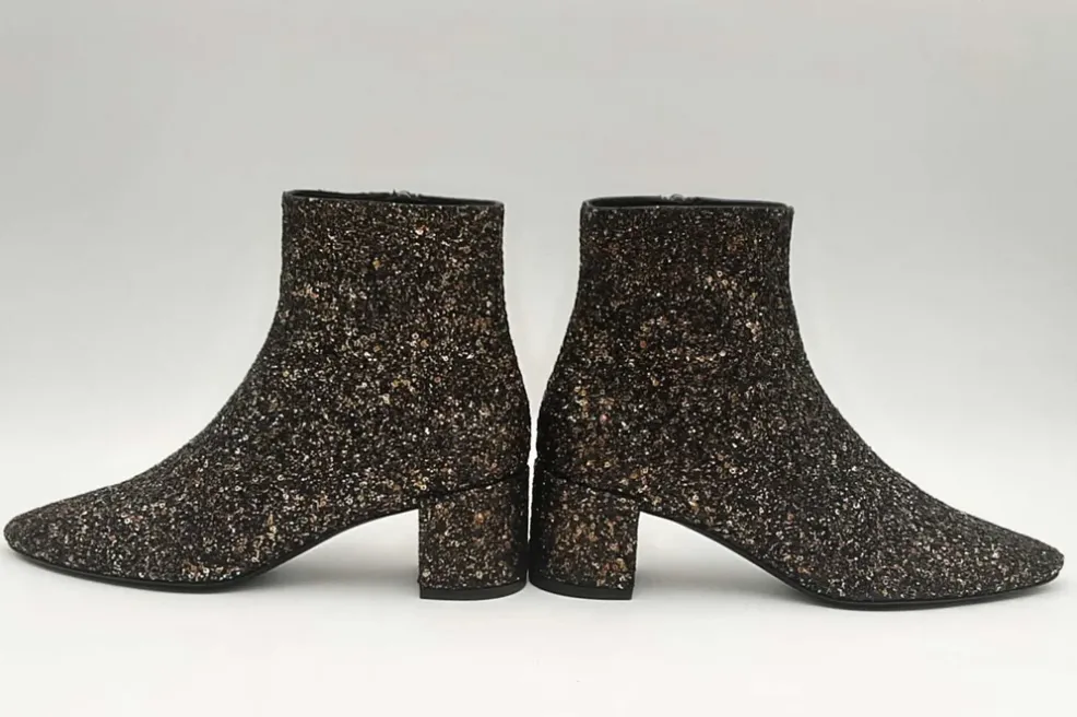 Glittery black ankle boots by Saint Laurent.