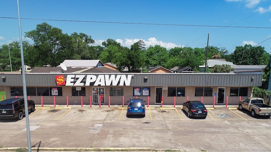 An aerial shot of the front of an EZPAWN pawn store.