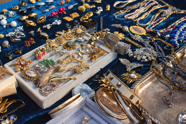 A bunch of new and old jewelry on a table is on display.